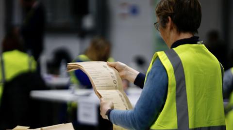 A person holding a ballot paper