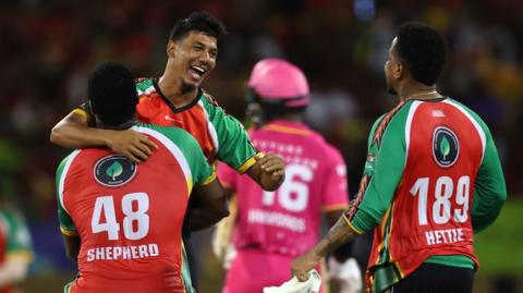 Gudakesh Motie of Guyana Amazon Warriors celebrates with teammates, Romario Shepherd and Shimron Hetmyer after getting the wicket of Kofi James of Barbados Royals during the Men's 2025 Republic Bank Caribbean Premier League match between Guyana Amazon Warriors v Barbados Royals at Providence Stadium