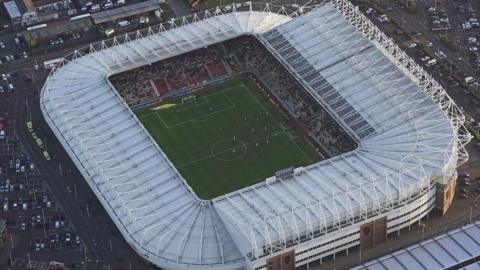 An aerial view of the Stadium of Light in Sunderland during a match. It is a rectangular structure with a large white outer frame.  