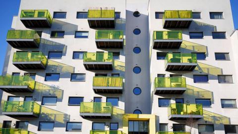 A block of flats in Camberwell, south-east London, with yellow glass balconies.