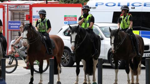 Four police officers on horseback in Leeds city centre