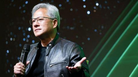 Nvidia CEO Jensen Huang holds a microphone as he speaks during a tech conference in Taiwan