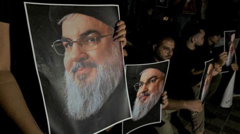 Supporters of Lebanon's Hezbollah leader Hassan Nasrallah carry his pictures as they gather in Sidon, Lebanon, following his killing