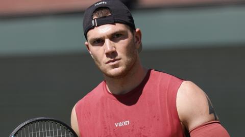Jack Draper with a pensive expression during a tennis match