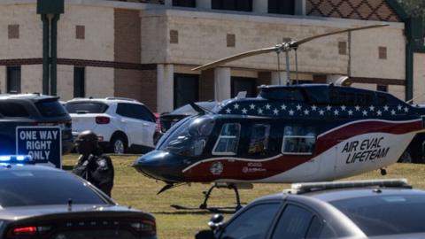 An evac helicopter and police officer at a school