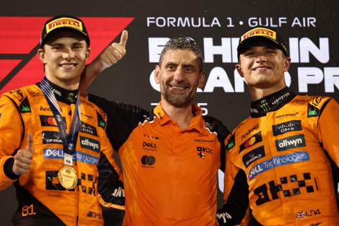 McLaren drivers Oscar Piastri and Lando Norris celebrate on the podium with team boss Andrea Stella after the Bahrain Grand Prix