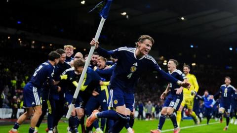 Scotland players celebrate on the pitch