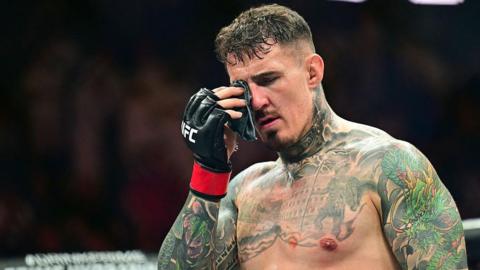Tom Aspinall holds his hurt eye at UFC 321