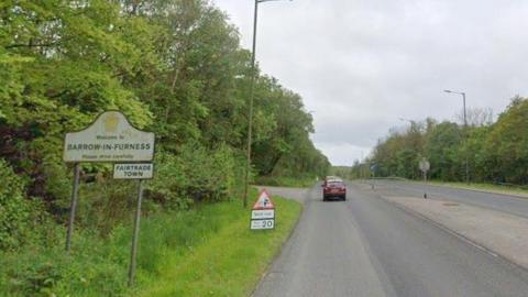 A Google Street View screenshot of the road entering Barrow, with a welcome sign.