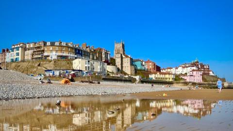 Picture taken on the beach, looking up at old houses lining the seafront