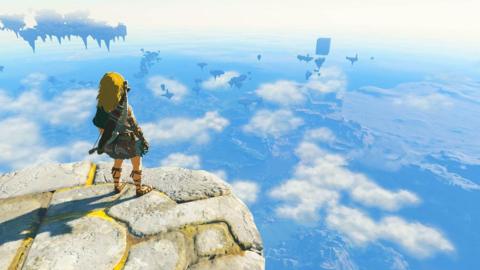 A screenshot from a video game showing a character, with long blond hair, a tunic and carrying a bow and arrows on his back, standing on the edge of a stone platform looking over a fantasy skyscape.