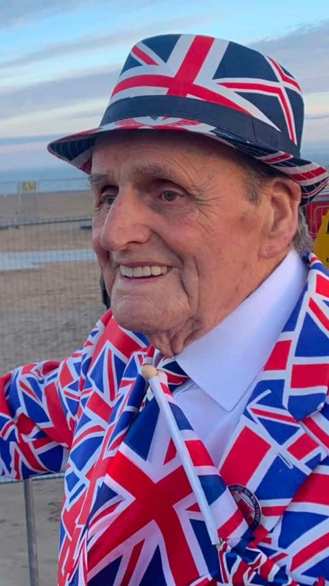 Man smiling in a union jack suit