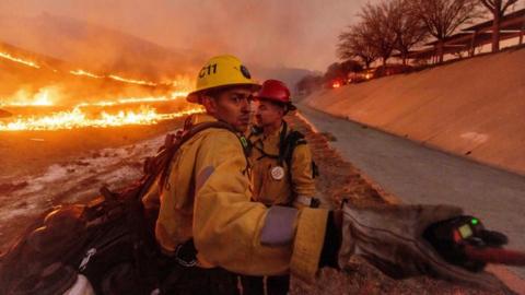 Fire crews battle the Kenneth Fire in the West Hills section of Los Angeles