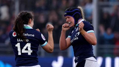 Sarah Bonar of Scotland celebrates scoring her team's first try with teammate Rhona Lloyd 