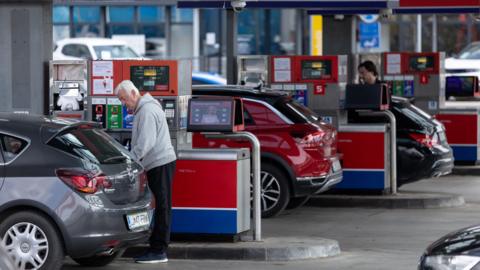 People at a petrol station in Slovenia