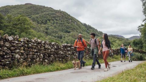 A family walking in the countryside.
