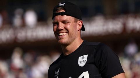 Matt Dunn smiling while playing for Surrey