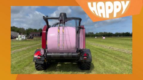 A tractor with a hay bale