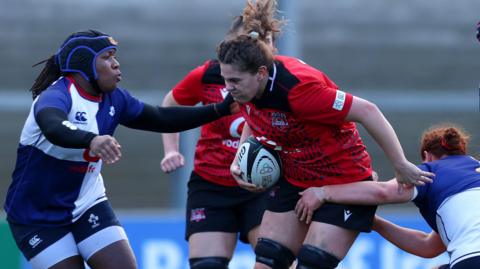  Linda Djougang and Caoimhe Molloy tackle Natalia John 