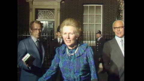 Margaret Thatcher stands in front of 10 Downing Street.