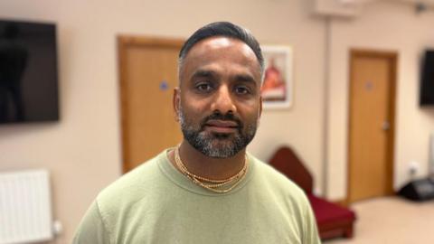 Shyam Govinda standing in the yoga-centre in Crawley where the Hari Krishna community is based. 