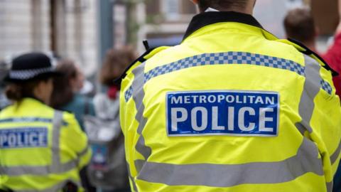 The back of a police officer's high vis jacket saying Metropolitan Police