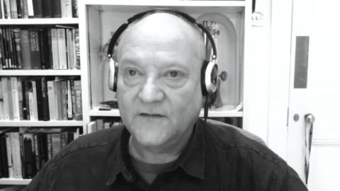 Prof. Russell Foster speaking and wearing headphones