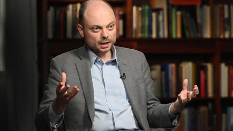 Man gestures as he speaks to camera