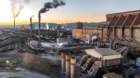 Aerial view of steel plant industry in Port Talbot with smoke rising into the sky