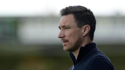 York City boss Stuart maynard looking to to the left of the picture in a blue fleece