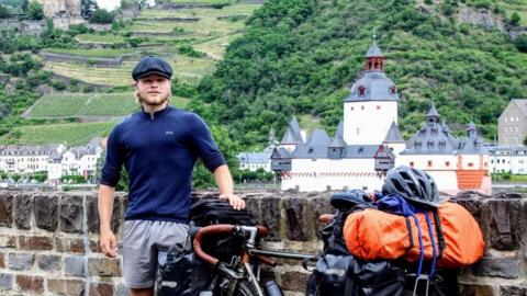 Jamie standing next to his bike.