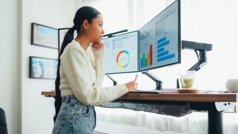 A woman works on a standing desk