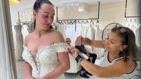 Agnieszka Uliasz has her replacement wedding dress altered