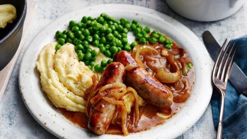 Sausages, mashed potato and peas with onion gravy