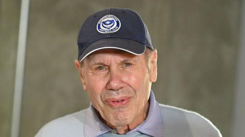 Portsmouth owner Michael Eisner in a blue club baseball cap