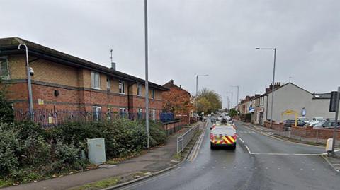 Deepdale Road, Preston, showing vehicles in a line of traffic and a car park on the right