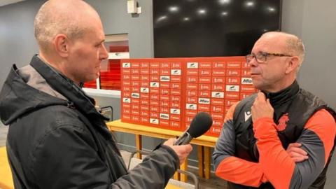 Lambs boss Andy Peaks is interviewed by BBC Radio WM's Mike Taylor in the Tamworth clubhouse