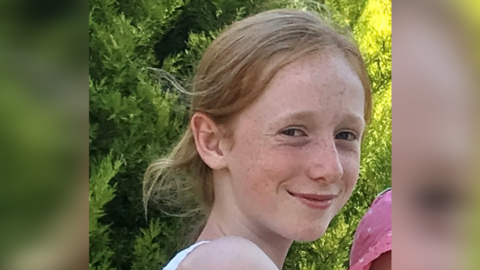 A picture of Ruth Szymankiewicz, a teenage girl who is smiling at the camera and has shoulder-length ginger hair.