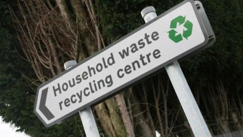 Household Waste and Recycling Centre sign in front of some trees and woodland