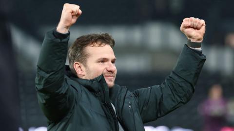 Watford boss Tom Cleverley with his fists in the air as he celebrates victory against Derby