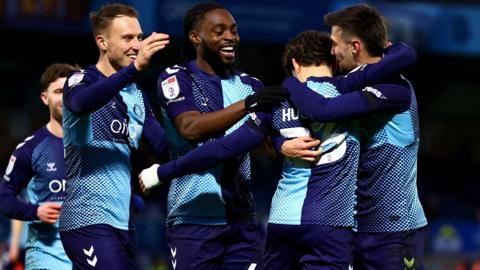 Wycombe players celebrate a goal