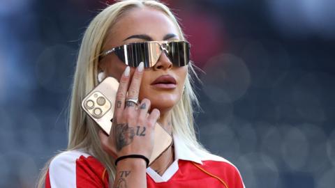 Alisha Lehmann in sunglasses and a red shirt