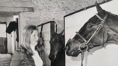 Gillian Fortescue-Thomas tends to her horse Stanhope Street at his stables