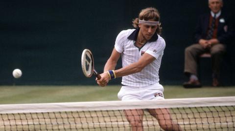 Tennis legend Bjorn Borg hitting a ball over the net 