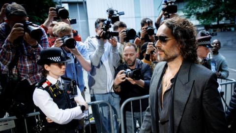 Russell Brand (R) arrives at Southwark Crown Court to enter his plea on charges of rape and sexual assault in London, Britain, 30 May 2025