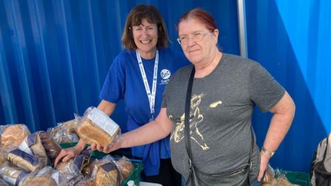 Gill Dolan (L) with pantry customer Barbara Turney