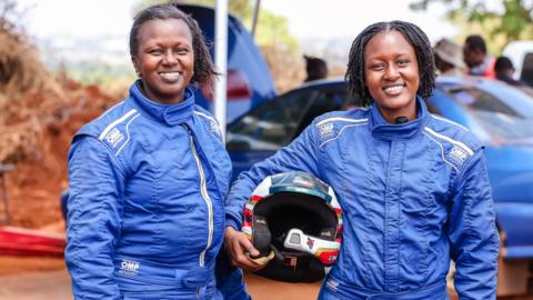 Caroline and Tinashe Gatimu shown in racing overalls