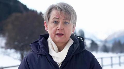 Yvette Cooper speaking to BBC Breakfast from Davos, in Switzerland dressed in a blue winter coat and white scarf, against a snowy backdrop