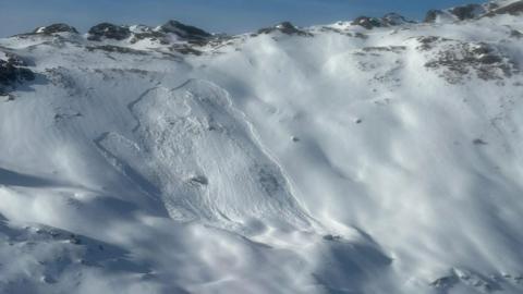 A handout from rescuers shows where the avalanche happened. You can see plenty of snow with mountains in the distance.