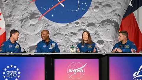 NASA's Artemis II mission astronauts, (L-R) commander Reid Wiseman, Victor Glover, Christina Koch and Canadian Space Agency's Jeremy Hansen attend a press conference at Johnson Space Center in Houston, Texas, on April 16, 2026. The astronauts did the first slingshot around the Moon in more than 50 years and traveled deeper into space than any humans before, culminating in a smooth splashdown on April 10 off the coast of California. 